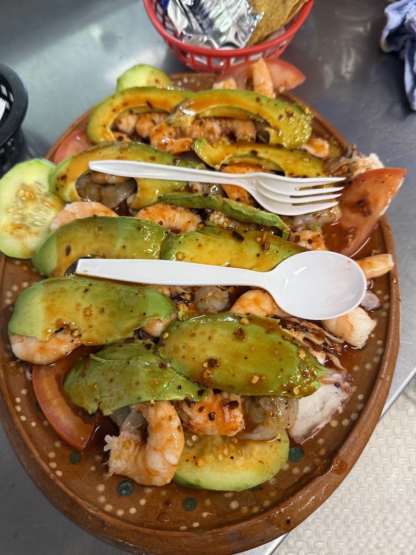 Colorful Mexican seafood dishes served together.